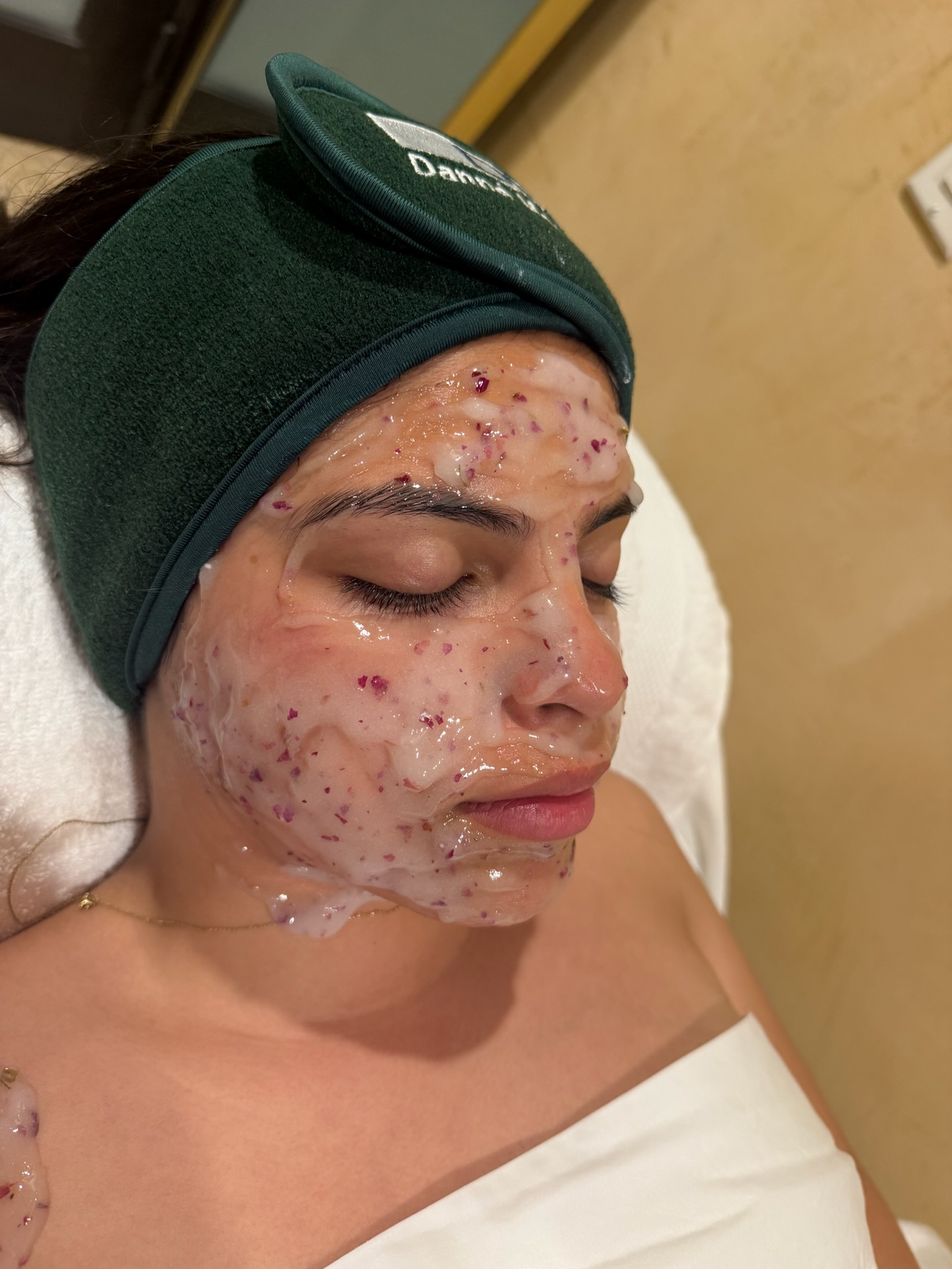 Client relaxing during a rose enzyme facial treatment at Icy Girl Esthetics